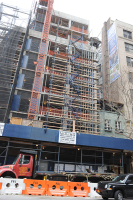 The eight-story condo building under construction next to Sharma's shop may have been used by the thieves to access his store.