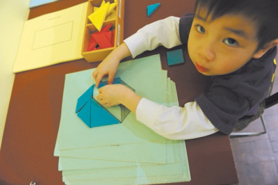 Samuel Lee, 33, tries his hand at a tangram—and succeeds.