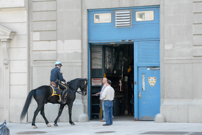 Top: Mounted officers from Troop A pose for pictures on North Moore Street. Above: The NYPD's horse stable on Varick Street is likely to be converted into the temporary World Trade Center Command post. 