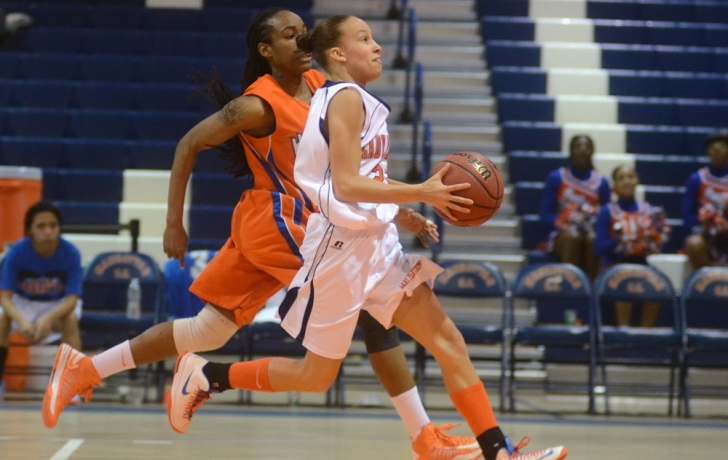 Ashley Coffee drives down court, shadowed by Hostos guard Justina Davis. Photo: Carl Glassman/Tribeca Trib Ashley Coffee drives down court, shadowed by Hostos guard Justina Davis. Photo: Carl Glassman/Tribeca Trib