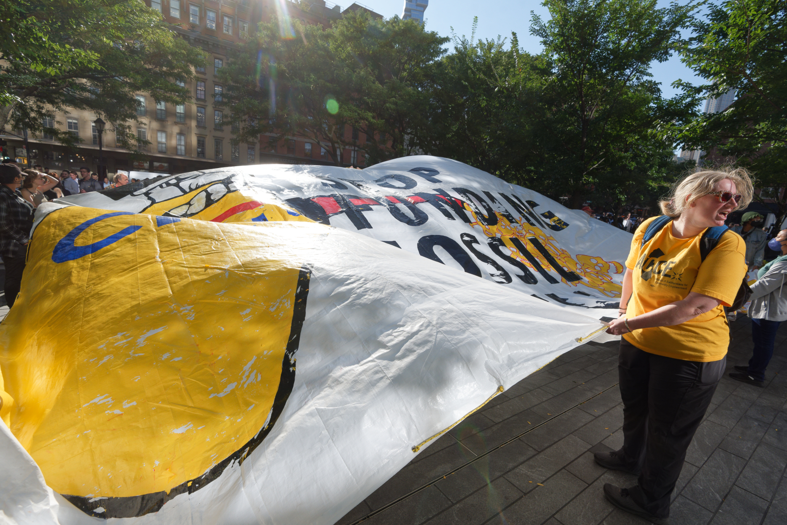 Activists waved a giant banner reading, “Stop Funding Fossil Fuels.” Photo: Carl Glassman/Tribeca Trib