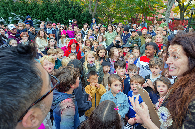 Lindsey Peers, with fellow judge Nico Victorino at left, announces the winners of the park’s Pumpkin Carving Contest. Photo: Carl Glassman/Tribeca Trib